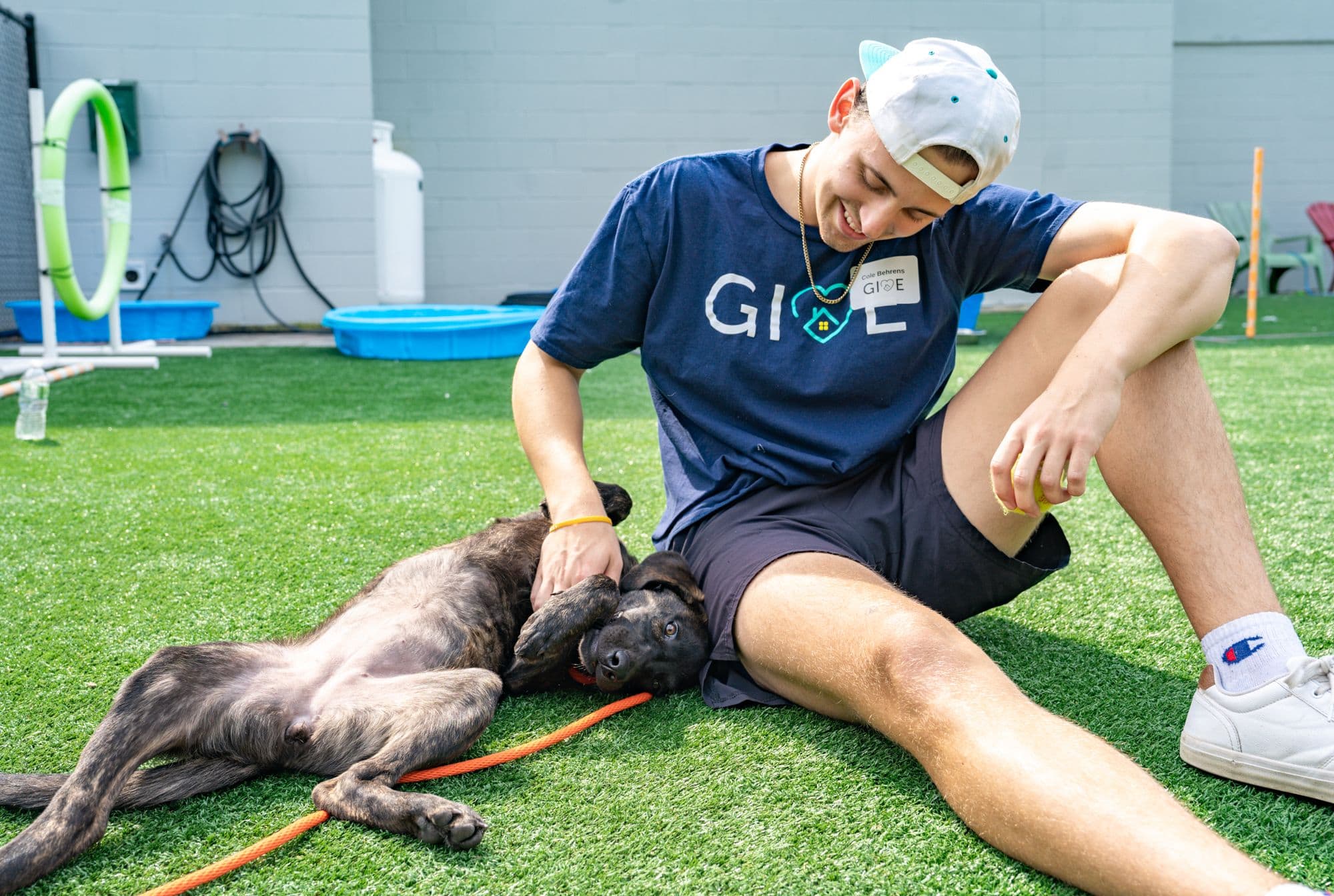 A man pampering his dog.